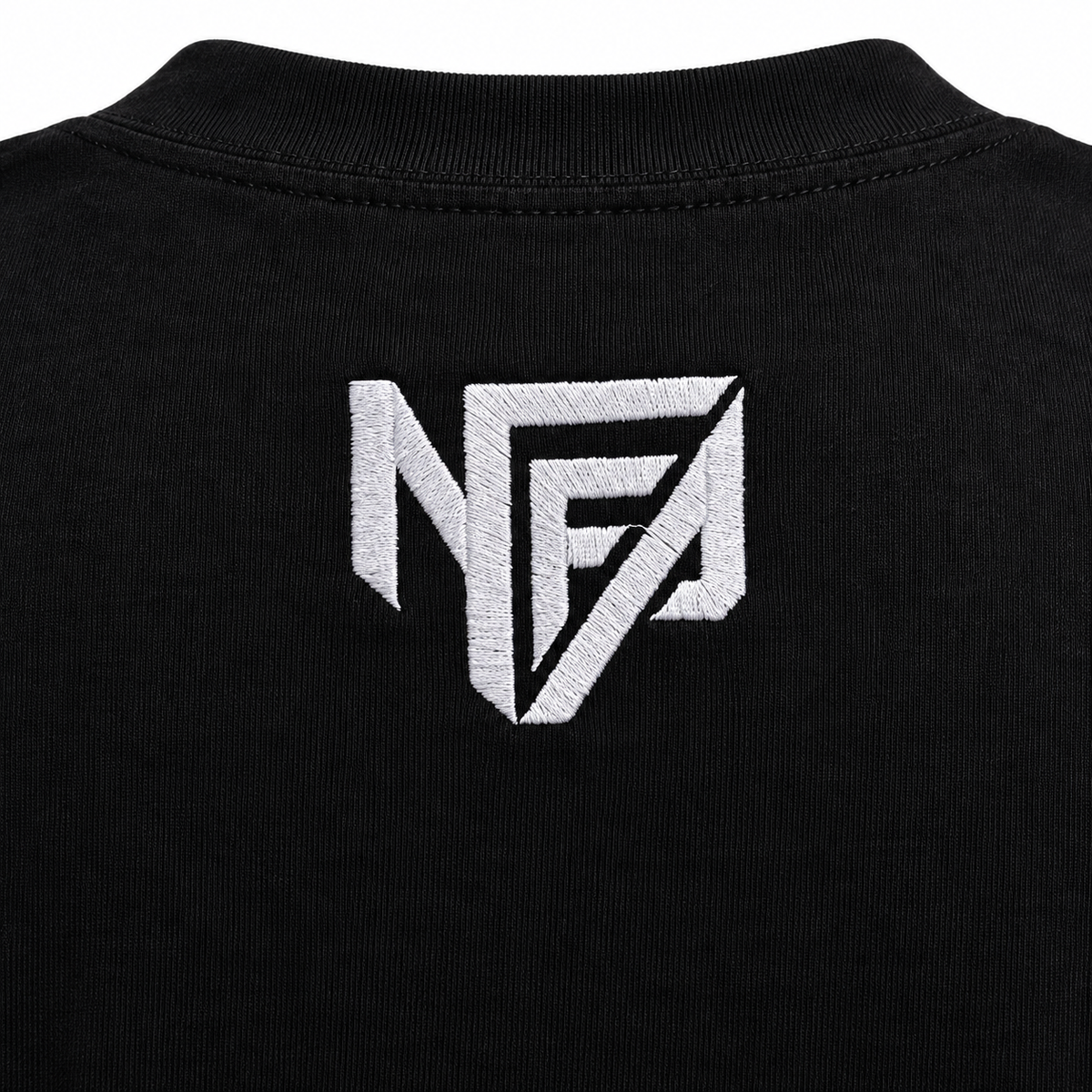 Close-up of the white embroidered NFA logo on the upper back of the black tee